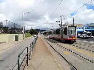 An inbound train passing the outbound platform at San Jose and Ocean station, 2018