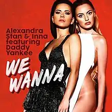 Stan and Inna posing close to each other in front of a red backdrop, sporting the outfits used for the single's music video.