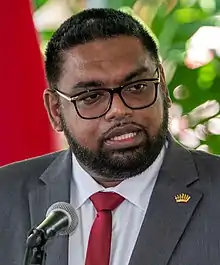 Ali speaking into a microphone