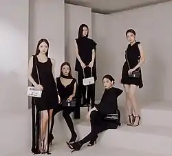 Five girls stand in a row against
