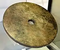 Jade disc (Bi). Nephrite jade. Liangzhu Culture, south-east China. Neolithic period, c. 2500 BCE. Victoria and Albert Museum