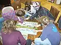 Several community members jigsaw puzzling at OCP.