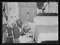 Woman sewing chair covers, bedspread, and other things made from cotton flour sacks in  Alabama.