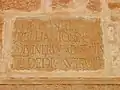 Close view of one of the Roman stones (with Latin inscriptions) reused at the base of the minaret