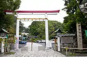 An unusual white and red Nakayama torii.