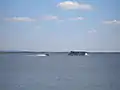 Tour boat and jetskis on Zemplínska Šírava near Klokočov during the summer season