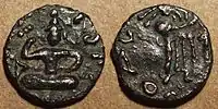 Coin of Kujula Kadphises.Obv Kujula seated cross legged facing, Kharoshti legend: Kuyula Kadaphasa Kushanasa.Rev Zeus on the reverse, Greek legend: ΚΟΖΟΛΑ XOPANOY ZAOOY.