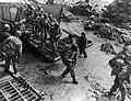 U.S Soldiers getting off their landing craft onto the rocky shores of Kiska Island, Alaska, on invasion day