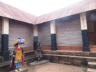 Central courtyard of the old palace of the rulers of Porto Novo featuring an Egungun.