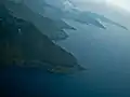 Aerial view of the southern shore with Sibandang Island visible in the background