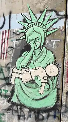 West Bank Wall graffiti art: An interpretation of Pietà showing Handala and Liberty