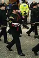 Riflemen in dark green No.1 dress uniform; bugler (foreground) in full dress busby.