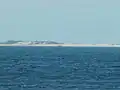 Wreck of the MV&nbsp;Sygna as seen from southern end of the beach, approximately 8.8&nbsp;km (5.5&nbsp;mi) to the south-west