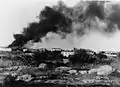 Food warehouse at Ma'ale HaHamisha on fire following Arab Legion shelling from Radar Hill, 1948