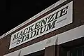 A stadium sign located near the left field entrance.