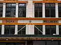 Signs on the side of the building now known as the Downing Centre