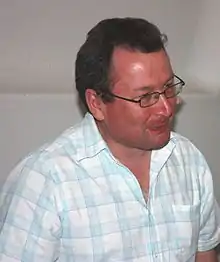 a man wearing rectangular glass facing right