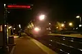 Train approaching the station in the evening.