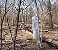 Milepost 6 located in Van Cortlandt Park; former railbed on left