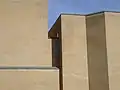 Cubist yellow brick facades lined with weathered copper plating