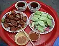 Nem chua rán with cucumber and chilli sauce