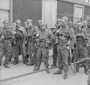 A group of 15 men in uniform carrying weapons