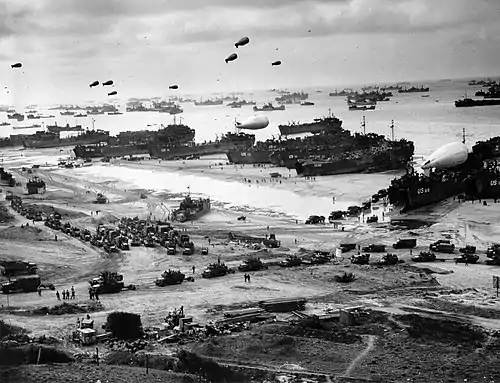 Image 10Invasion of NormandyPhoto credit: United States Coast GuardLanding ships putting ashore on Omaha Beach at low tide during the first days of the Invasion of Normandy, mid-June, 1944. Barrage balloons fly overhead and U.S. Army "half-tracks" form a convoy on the beach. The Normandy landing was the largest seaborne invasion in history, with almost three million troops crossing the English Channel.More featured pictures