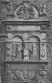 A mural monument in late renaissance style showing a man in armour and a woman kneeling in prayer