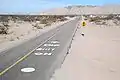 Road markings south of the dip with the vado to the north beyond on Fed.&nbsp;5.[clarification needed]