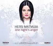 The image depicts a woman staring at the camera with her hands closed