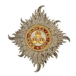 Civil Knight Grand Cross Star of The Most Honourable Order of the Bath: "Rays of silver issuing from a centre and charged with three Imperial Crowns, one and two, within a circle gules whereon inscribed the motto of the Order in gold"Montague-Smith, P. W. (ed.), Debrett's Peerage, Baronetage, Knightage and Companionage,  Kelly's Directories Ltd, Kingston-upon-Thames, 1968, p. 896.