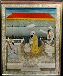 Paining of Mahan Singh (father of Maharaja Ranjit Singh) seated underneath a red canopy