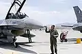 An officer performs a post-flight inspection after the Griffins arrive at Red