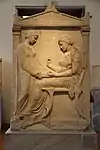 Funerary stele in which appears somebody staying on a klismos, from circa 410-400 BC, in the National Archaeological Museum (Athens, Greece)
