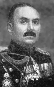 Black and white portrait of a dark-haired man wearing dress uniform with medals