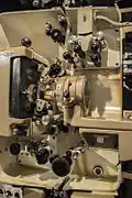 35mm film threaded in the mechanism (white spacing), through the picture gate and analog optical audio head.
