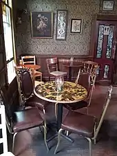 Photograph of a building's interior with tables and chairs set up for dining
