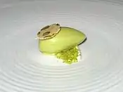 Pistachio ice cream over whipped mascarpone topped with pistachio biscotti