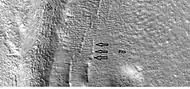 Close-up that shows cracks containing pits on the floor of a crater, as seen by HiRISE under HiWish program.  Cracks may start as a line of pits that enlarge, then join.