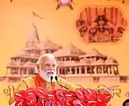 PM Modi at the foundation stone laying ceremony of Ram Temple with proposed architecture design in background.