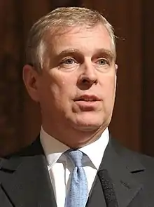 Andrew standing at a lectern speaking