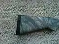 Remington 870 shotgun equipped with a recoil pad.