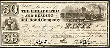 Philadelphia and Reading Railroad Company 50 dollar bill. Bill has several small circular holes punched through the signatures of the Treasurer and Engineer. Images include Liberty, seated, with shield, caduseus, and sailing vessels; a busy railway station with cars on four different tracks; and a horse.