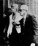 Black and white photograph of Ronald Ebens, wearing a suit and sunglasses, entering the United States District Court for the Eastern District of Michigan
