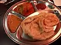 Roti canai with curry chicken in New Zealand.