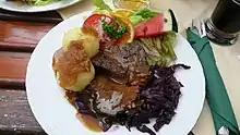 Sauerbraten served with Kartoffelklöße (potato dumplings) is a German Dish.