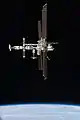 Full starboard side view of the station as Atlantis begins its half-loop fly-around