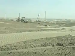 Sand dunes and an oil well donkey on the Cheleken Peninsula, Balkan Province, Turkmenistan