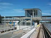 Approaching Sea Island Centre station from the west. Access to the station is via an elevated walkway above the tracks and adjacent roads.