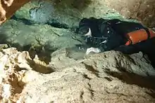Sidemount diver in fairly tight space